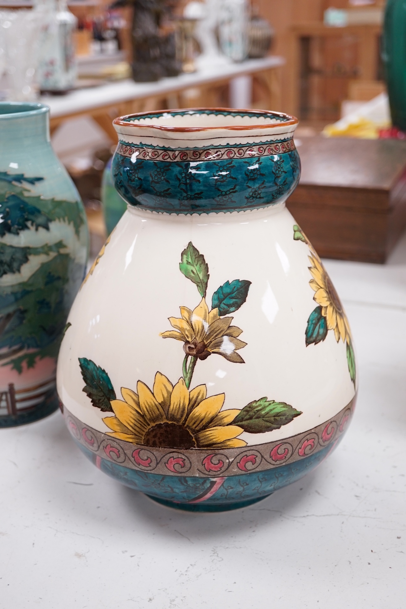 A Doulton stoneware Art Nouveau style vase, a Poole pottery vase and two other pieces, largest 27cm high. Condition - good